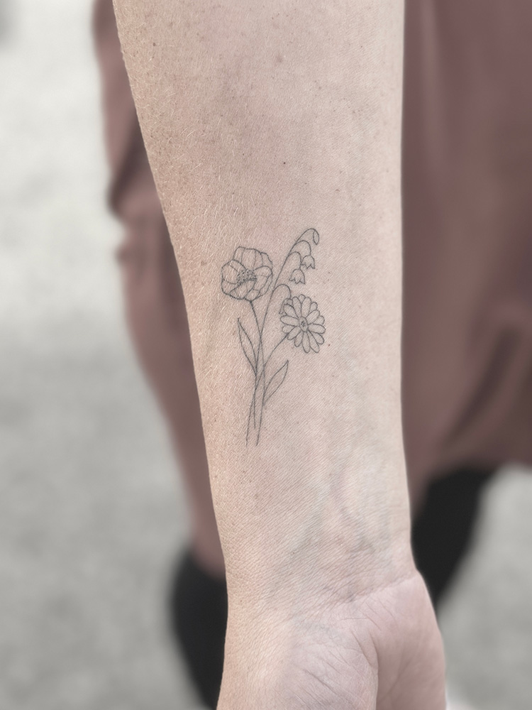 Fineline flowers on the forearm